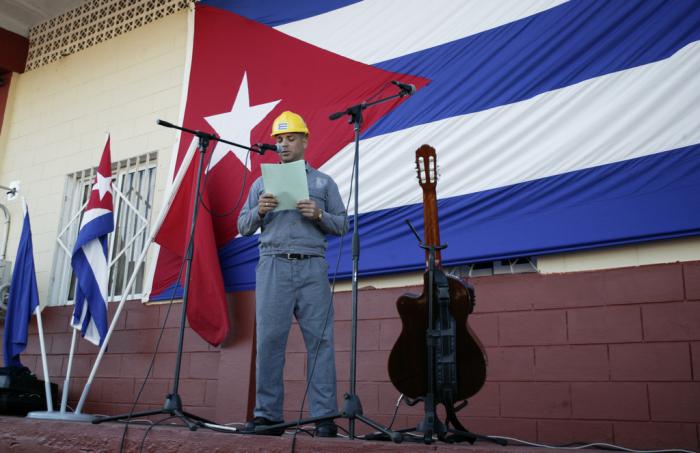 electrico leyendo con bandera cubana