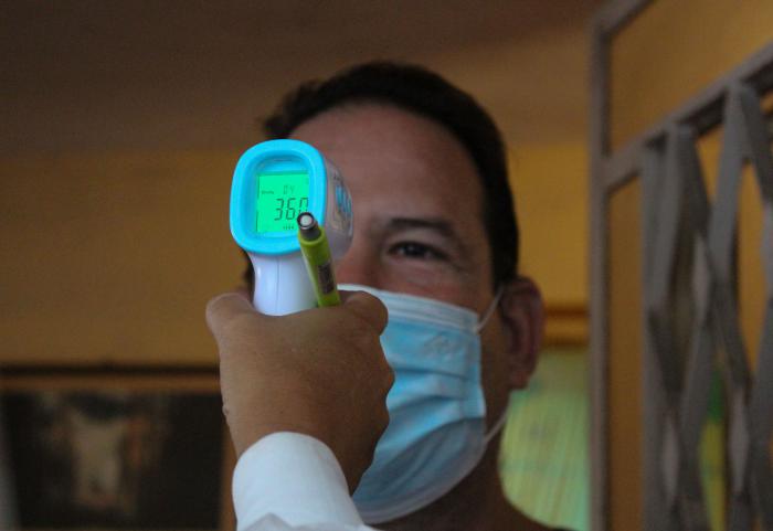 Una persona que le miden la temperatura corporal con un termómetro digital