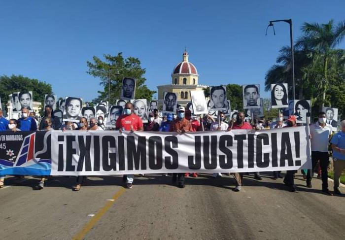 El pueblo habanero en el acto por el aniversario 45 del crimen de Barbados, con un cartel que dice: ¡Exigimos justicia!