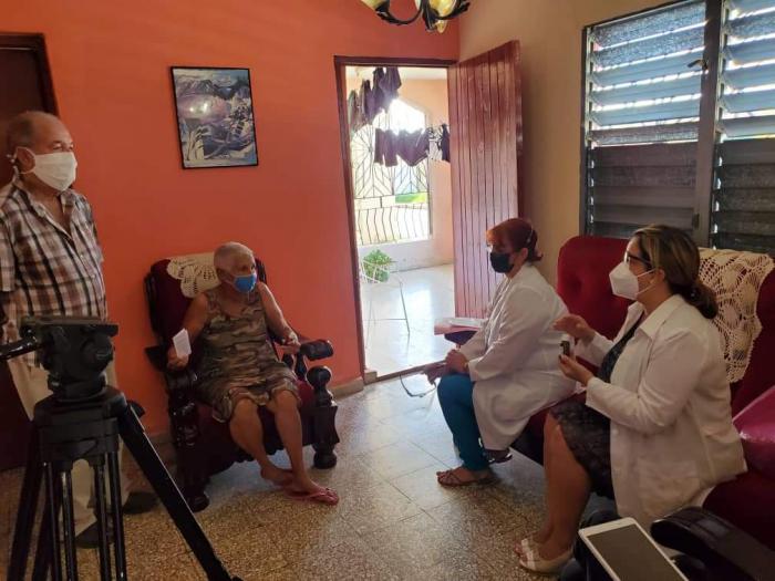 Personal del proyecto en una casa explicando sobre las características del Curmeric