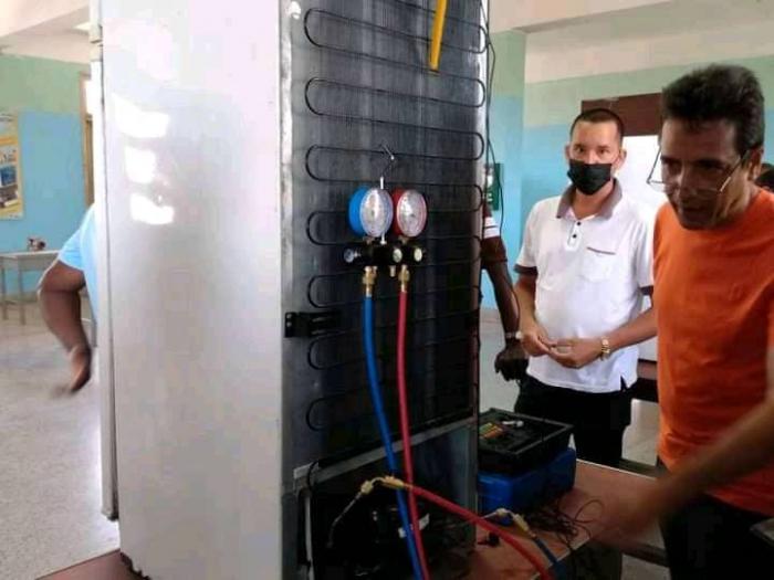Técnicos con un refrigerador