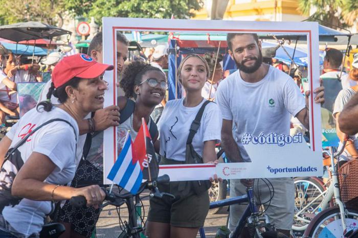 Jóvenes en la caravana con banderas cubanas