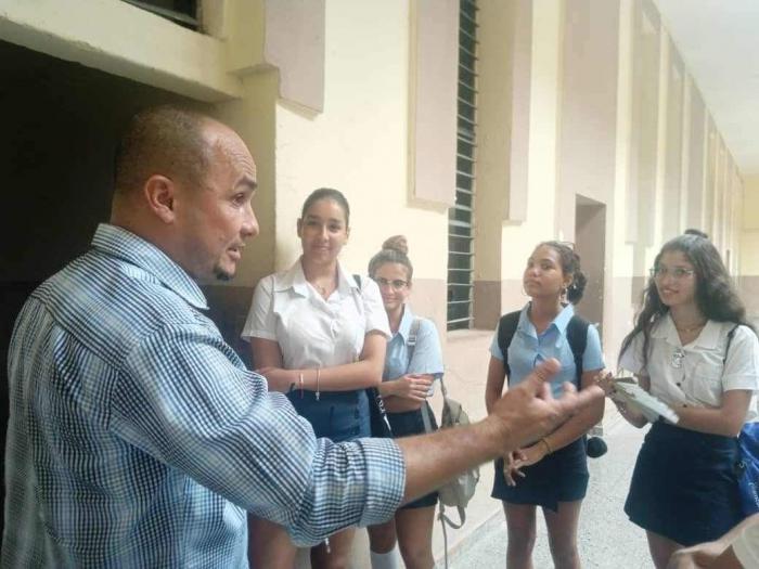 El miembro del Buró Provincial del Partido Comunista de Cuba (PCC) que atiende la Educación, la Cultura y el Deporte, Roilán Rodríguez Barbán, junto a cuatro estudiantes.